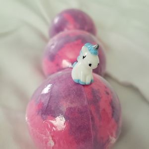 Bath bombs with mini unicorn inside.